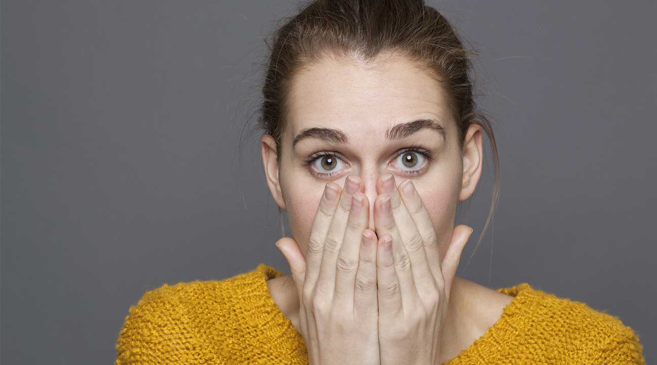 woman covering her mouth