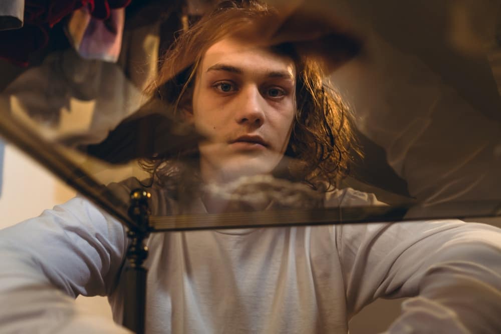 young man staring a table covered in cocaine white powder