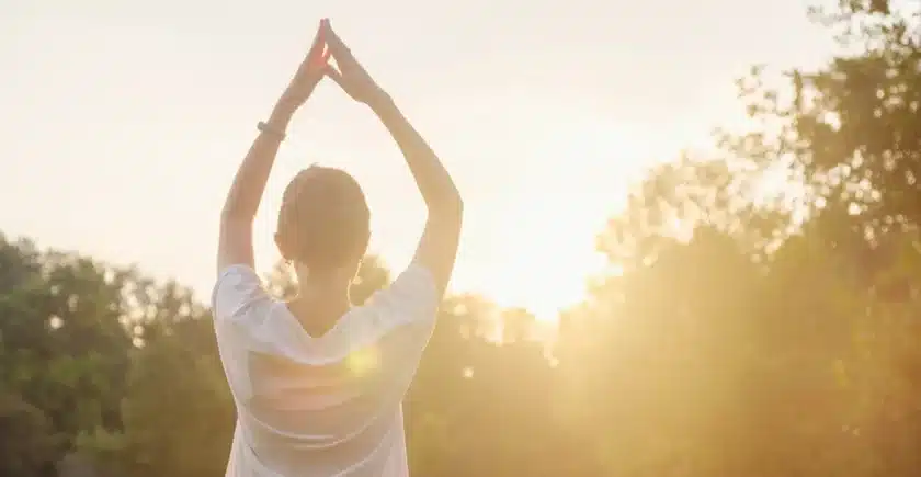 A man stretching in the sun.